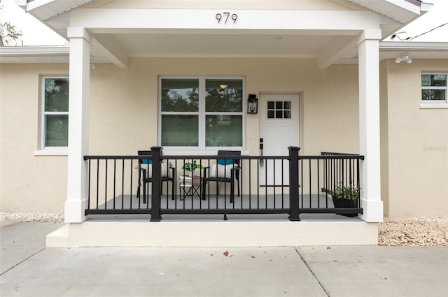 view of exterior entry with a porch