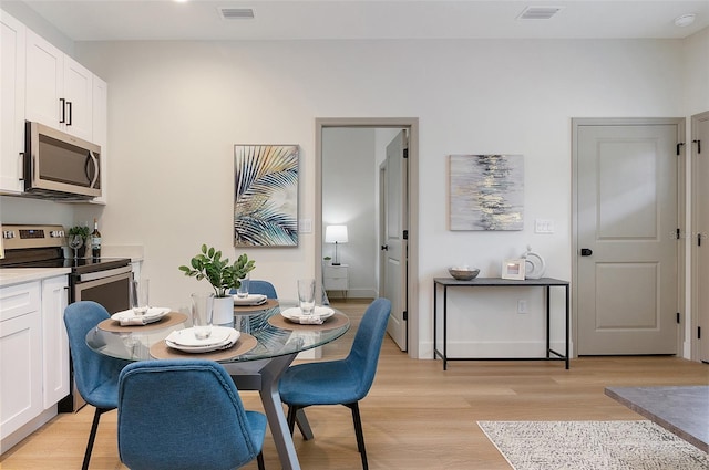 dining space featuring light wood-type flooring