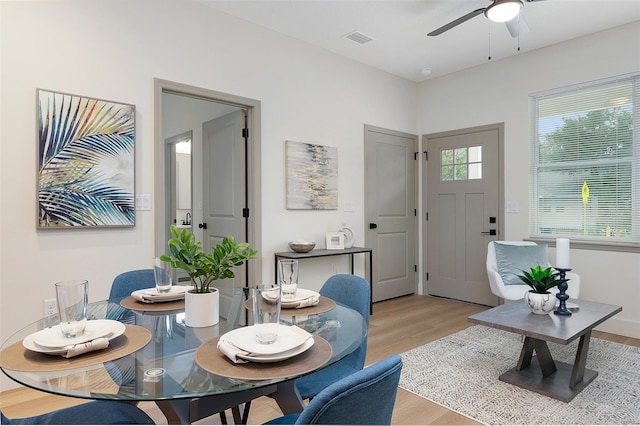 dining room with ceiling fan and light hardwood / wood-style floors