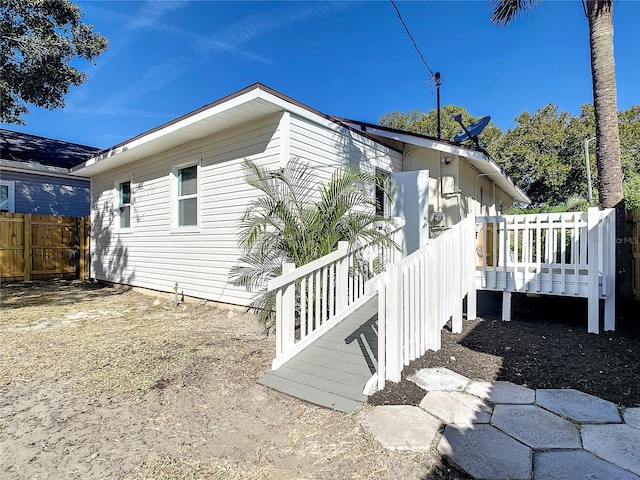 view of side of home featuring a wooden deck