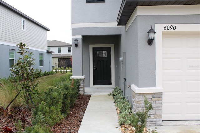 doorway to property with a garage