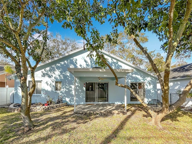 back of house with a patio, ceiling fan, and a lawn