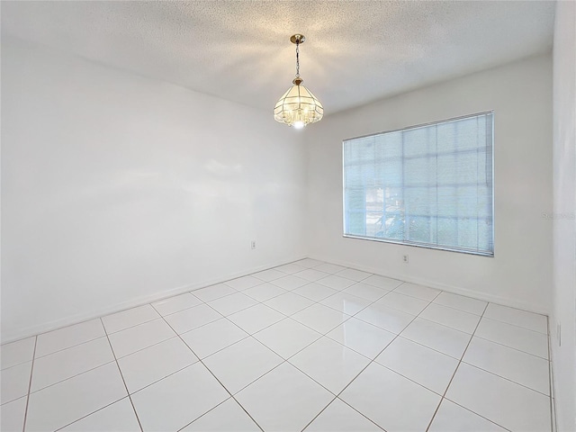 empty room featuring a textured ceiling