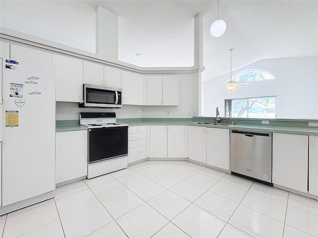 kitchen with sink, ceiling fan, appliances with stainless steel finishes, white cabinetry, and decorative light fixtures