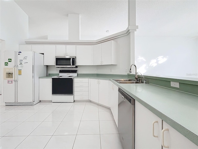 kitchen featuring sink, light tile patterned floors, stainless steel appliances, white cabinets, and a textured ceiling