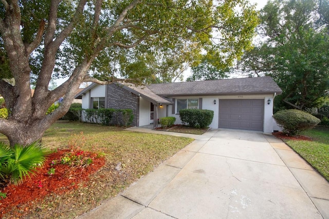 ranch-style house with a garage and a front yard