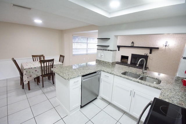 kitchen with sink, dishwasher, kitchen peninsula, electric stove, and white cabinets