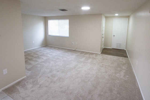 spare room with light colored carpet