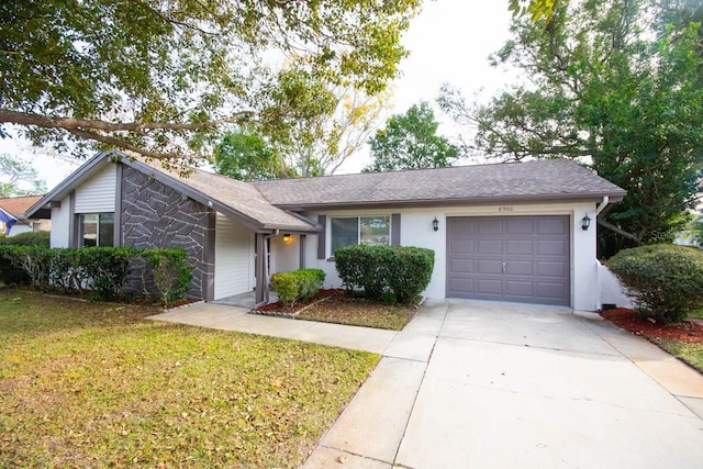 ranch-style home with a garage and a front lawn