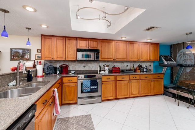 kitchen with light tile patterned flooring, appliances with stainless steel finishes, decorative light fixtures, sink, and a tray ceiling