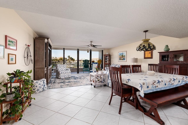 tiled dining space featuring ceiling fan and a textured ceiling