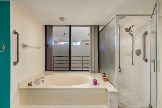 bathroom featuring independent shower and bath