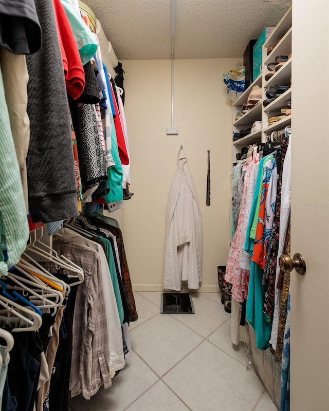 spacious closet featuring light tile patterned flooring