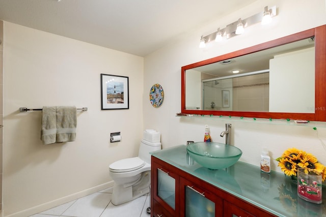 bathroom with tile patterned flooring, vanity, an enclosed shower, and toilet