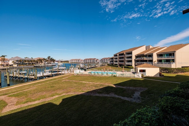 view of yard featuring a water view and a boat dock