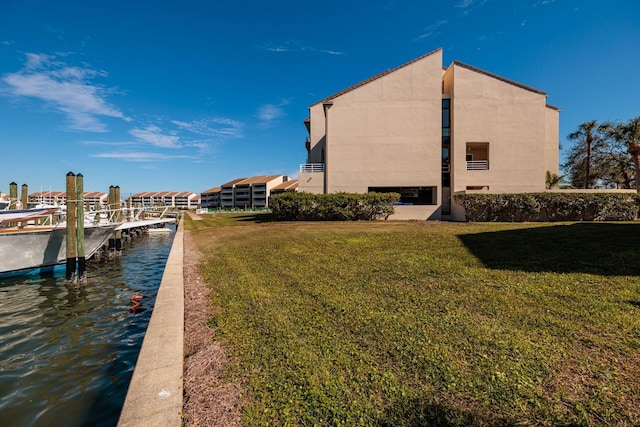 exterior space featuring a water view and a lawn