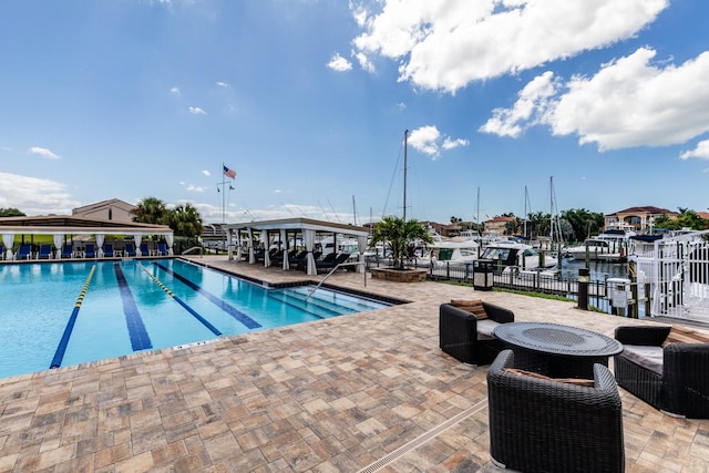 view of pool featuring a patio area and a fire pit