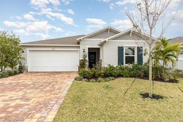 view of front of home featuring a garage and a front lawn