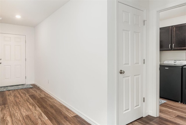 hallway with washer / clothes dryer and dark hardwood / wood-style floors