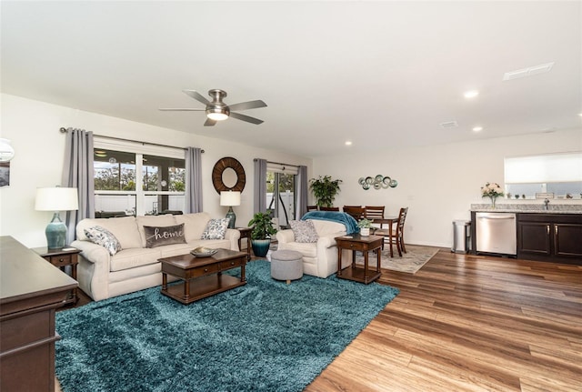 living room with ceiling fan and hardwood / wood-style floors