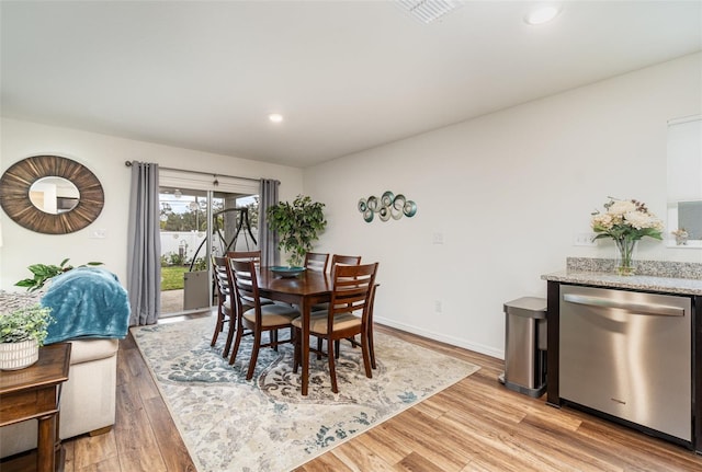 dining space featuring light wood-type flooring