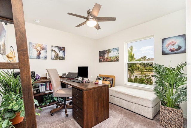 home office with light carpet and ceiling fan