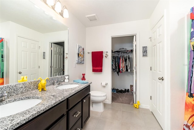 bathroom featuring tile patterned floors, vanity, and toilet