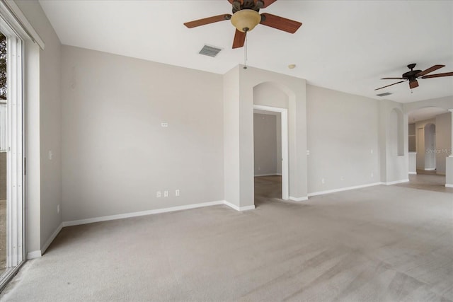 empty room with ceiling fan and light colored carpet