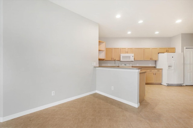 kitchen with light tile patterned flooring, white appliances, and light brown cabinetry