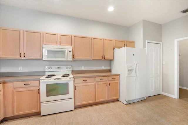 kitchen with white appliances and light brown cabinets