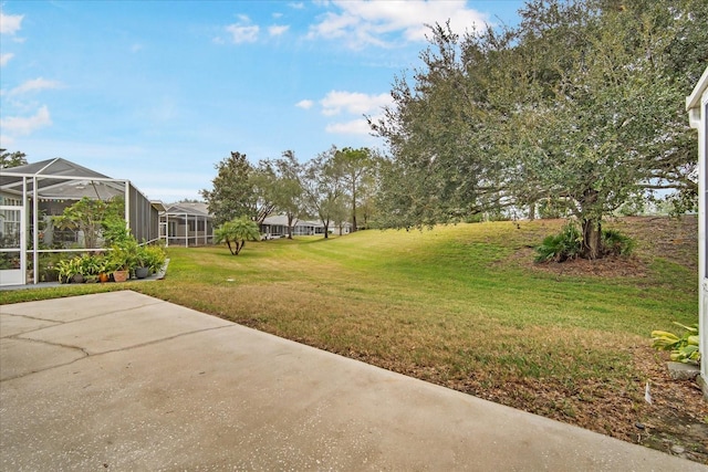 view of yard featuring a lanai and a patio area