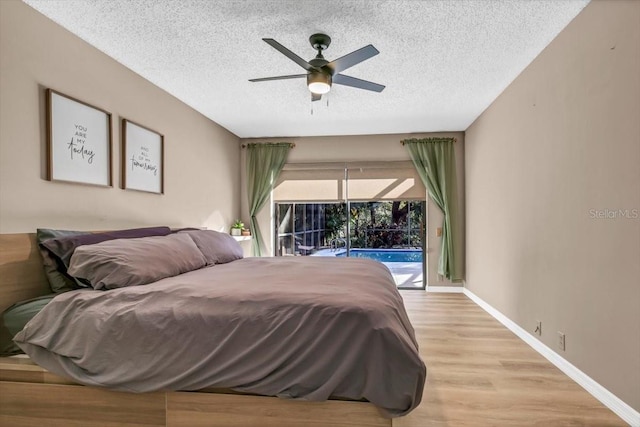 bedroom featuring a textured ceiling, access to outside, light hardwood / wood-style floors, and ceiling fan