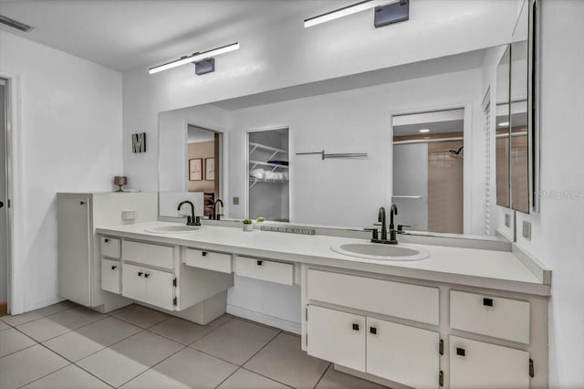 bathroom featuring tile patterned flooring and vanity