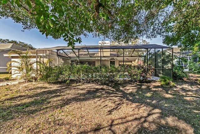 view of yard with glass enclosure