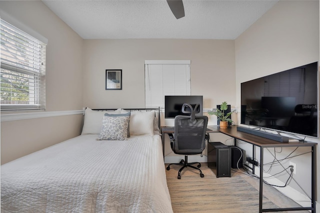 bedroom featuring a textured ceiling and ceiling fan