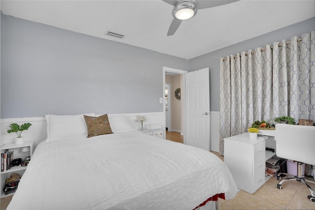 tiled bedroom featuring ceiling fan