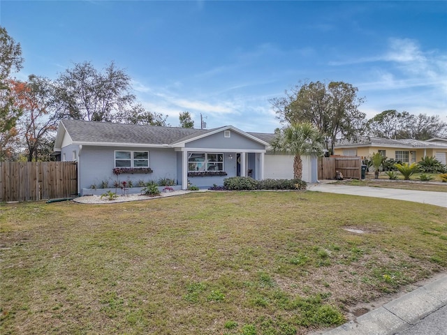 ranch-style house featuring a garage and a front yard