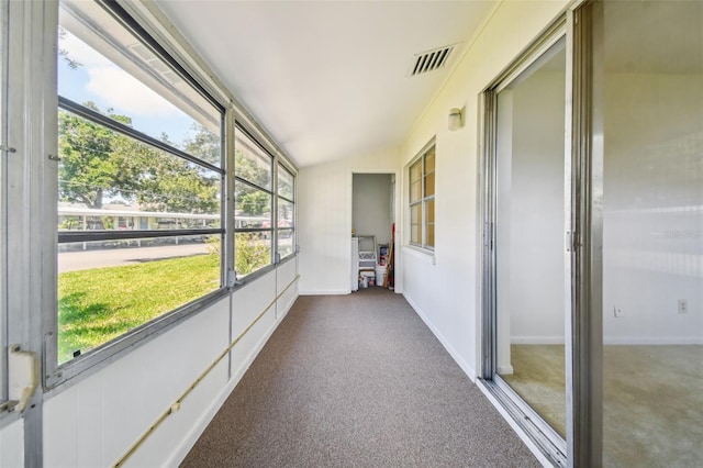 unfurnished sunroom featuring vaulted ceiling