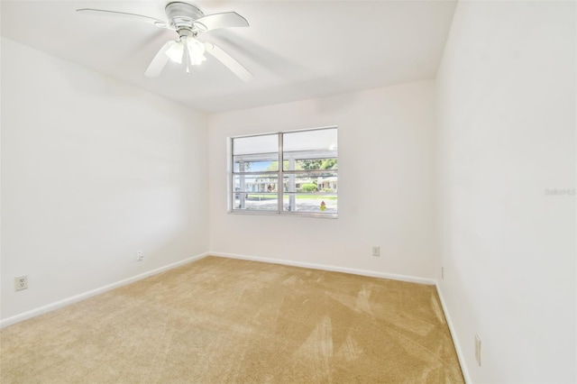 unfurnished room with ceiling fan and light carpet