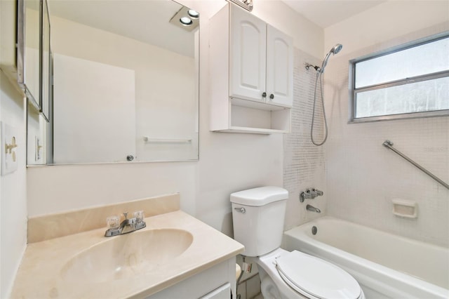 full bathroom featuring toilet, tiled shower / bath, and vanity