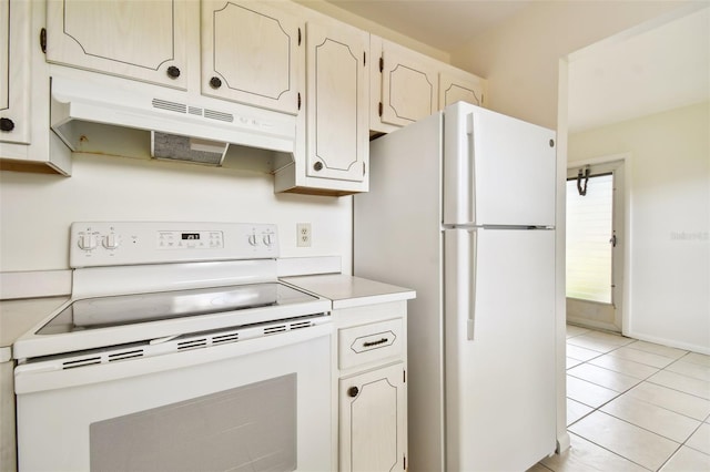 kitchen featuring white appliances and light tile patterned flooring