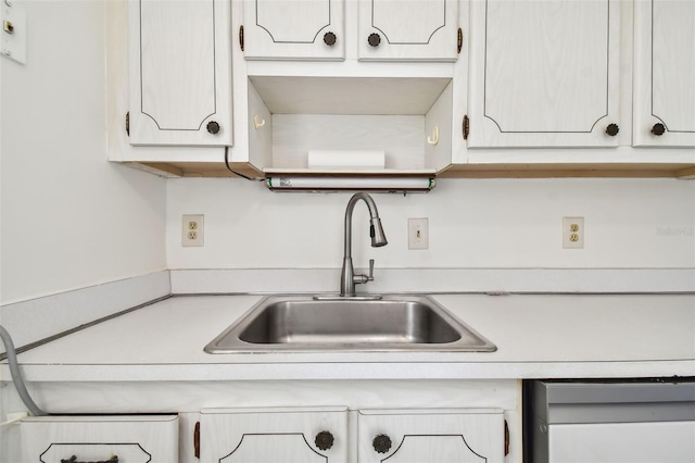 kitchen featuring sink and white cabinetry