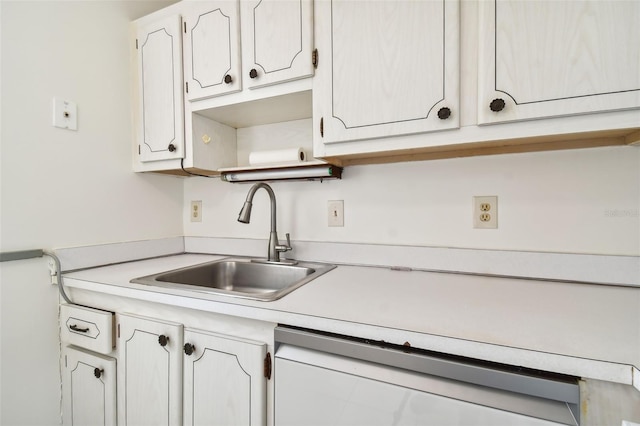 kitchen with sink, white cabinetry, and dishwasher