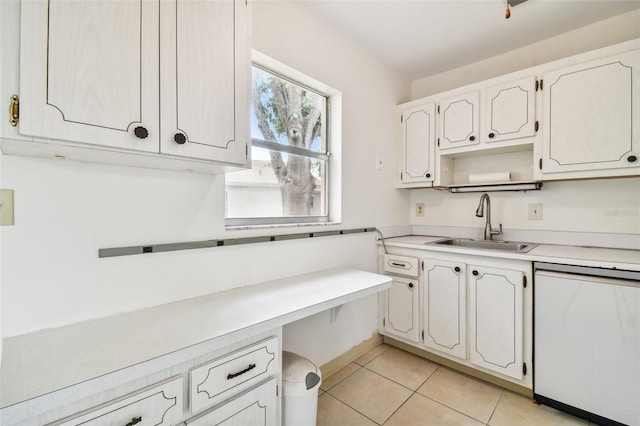 kitchen with sink, light tile patterned flooring, white cabinets, and dishwasher