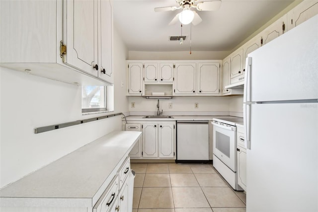 kitchen featuring white appliances, white cabinetry, light tile patterned floors, sink, and ceiling fan