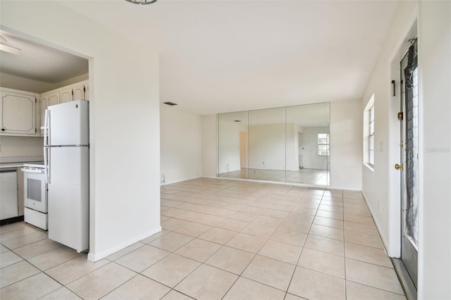 kitchen with white appliances and light tile patterned floors