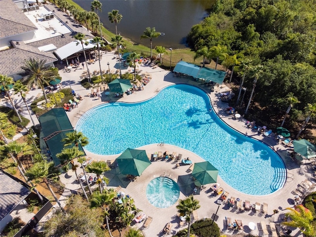 view of pool featuring a patio and a water view