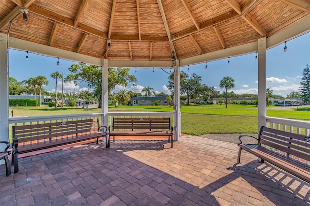 view of property's community with a patio, a gazebo, and a lawn