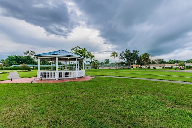 surrounding community with a gazebo and a yard