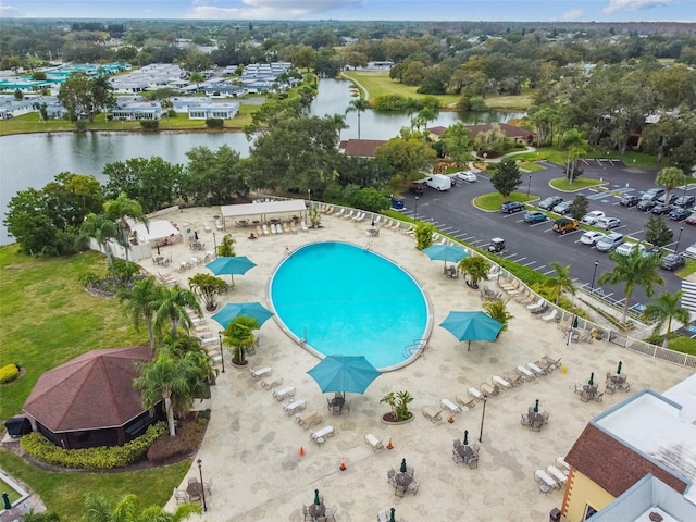 view of pool with a patio area and a water view